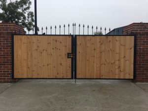 Black powder-coated metal gate with timber cladding custom fabrication by NS Metal Crafting